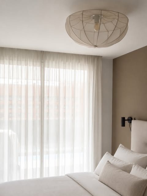 Completed bedroom with linen bedding and rattan pendant light